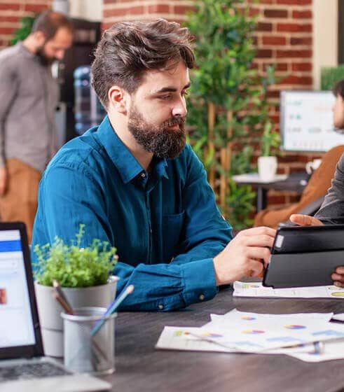 Business professional reviewing information on a tablet