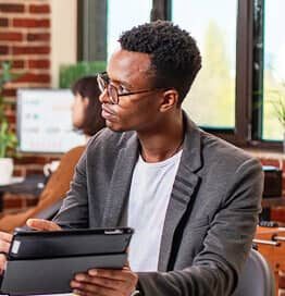 Professional holding a tablet during a business review